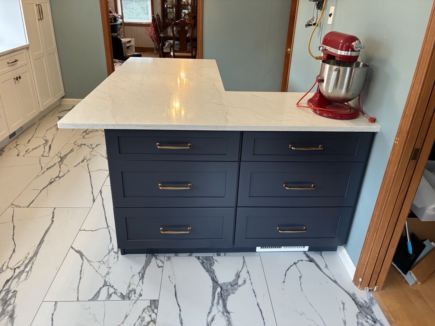 Detail of the navy kitchen island with brass hardware