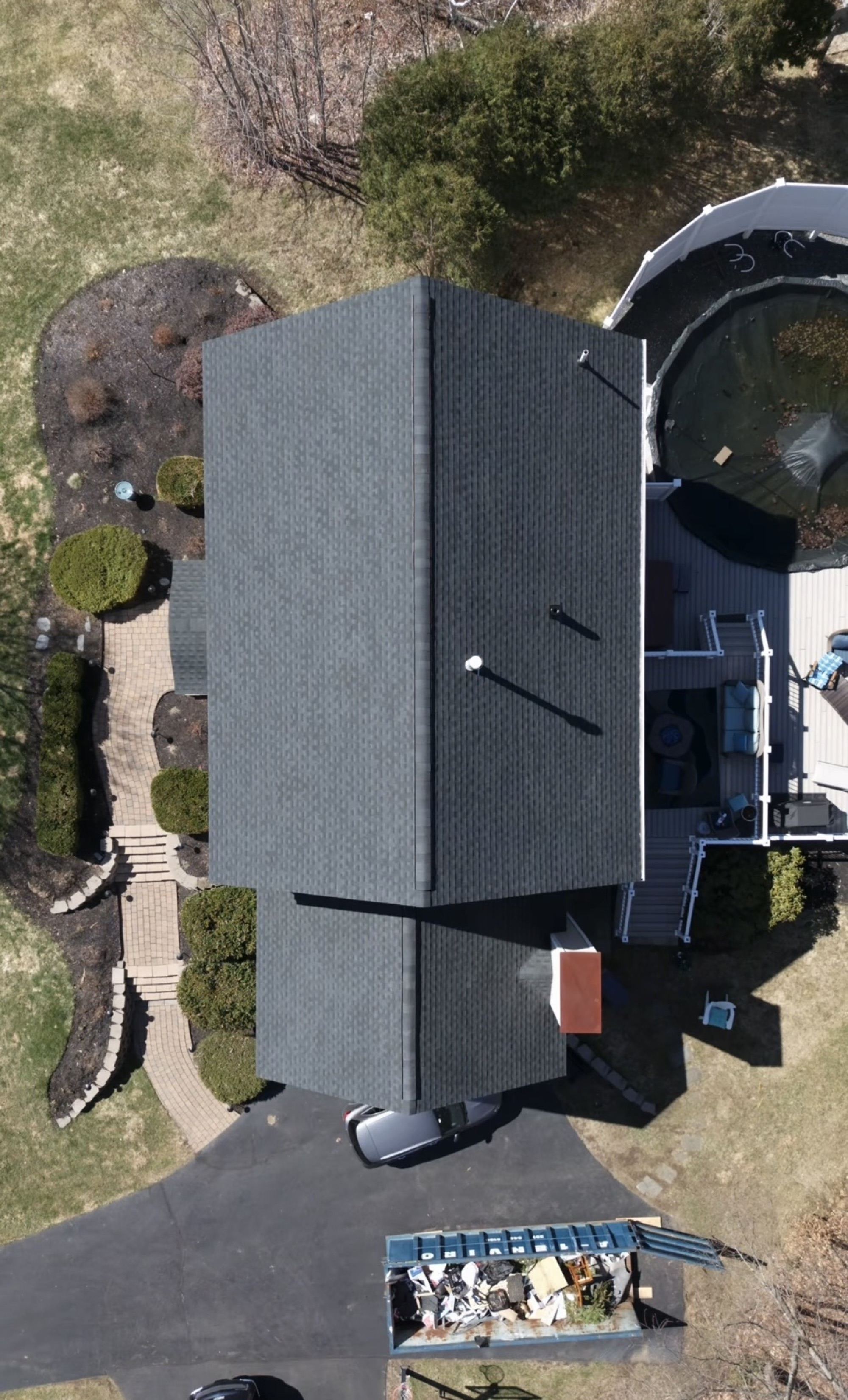 Aerial view of the completed black asphalt shingle roof