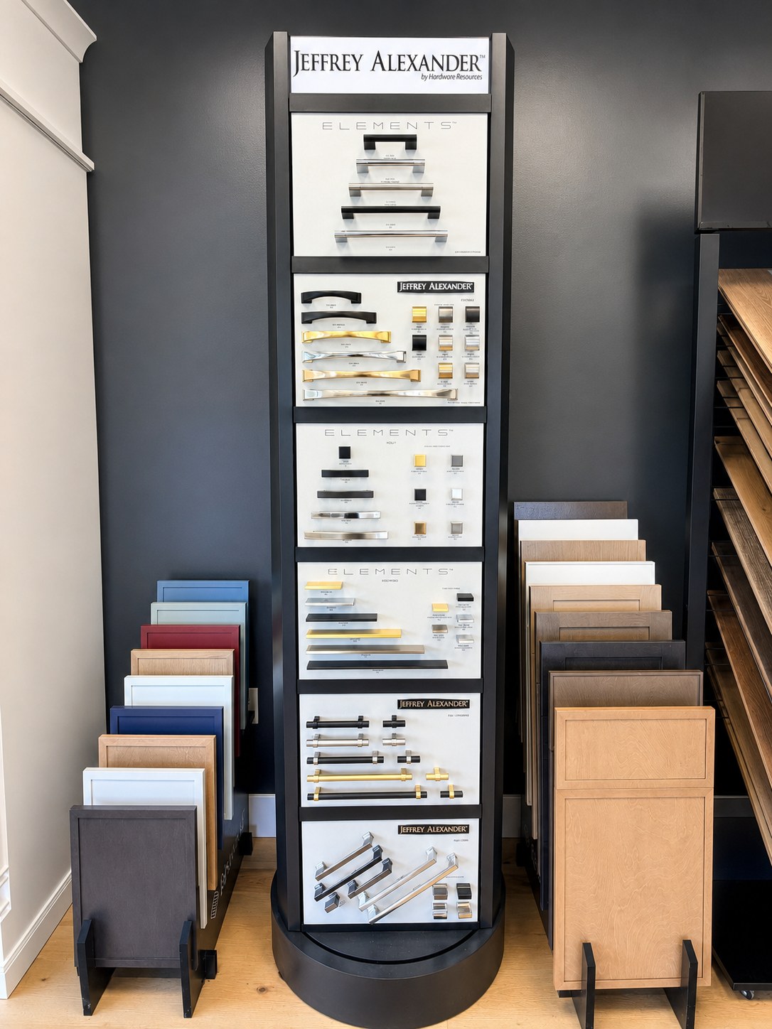 Cabinet hardware display: pulls and knobs mounted to compare by hand